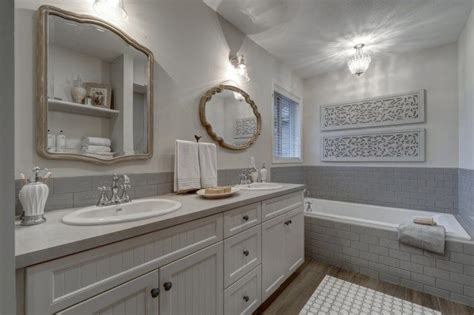 A Large Bathroom With Two Sinks And A Bathtub In The Corner Along With