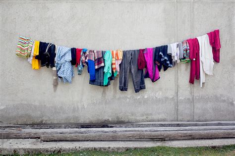 Colourful Wet Laundry Hanging To Dry In Front Of A Wall Del