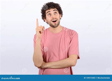 Young Man Shocked Pointing Up Stock Image Image Of Directing