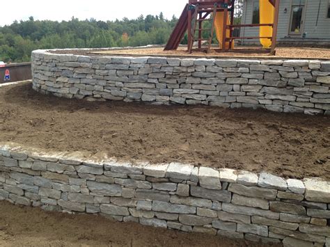 Maybe you would like to learn more about one of these? Natural stone retaining walls during construction by Bahler Brothers | Stone backyard, Landscape ...