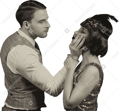 Фото Злой ревнивый мужчина хватает женщину за лицо