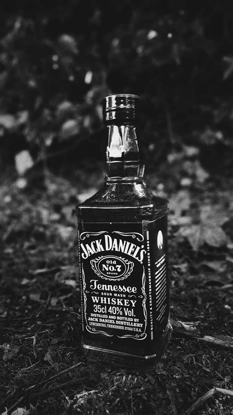 A Bottle Of Jack Daniels Whiskey Sitting On The Ground