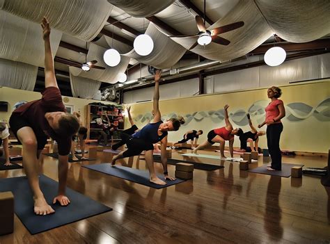 a group of people doing yoga in a room