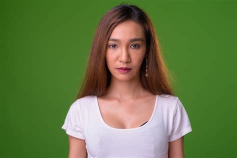 Premium Photo Young Slim Asian Woman Against Green Background