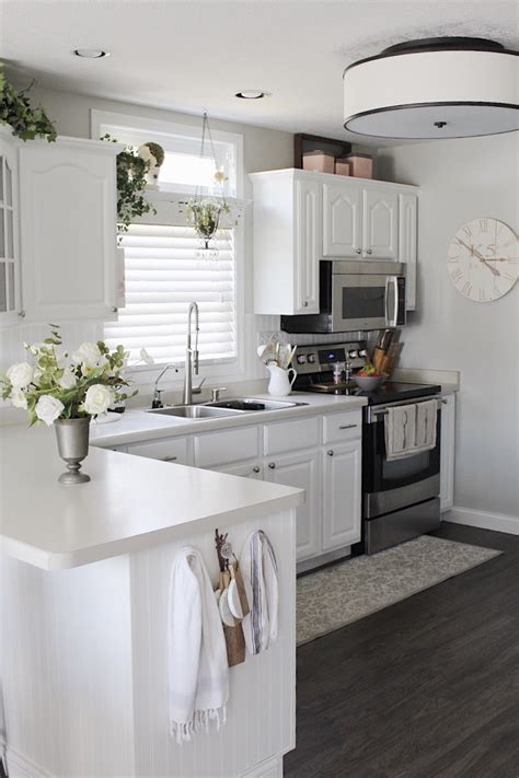White cabinets in this stylish and detailed kitchen help to provide a contrast to the primarily creamy and peach colors. White Kitchen Cabinets - Still the Best Decision - Simple ...