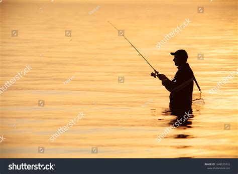 Unrecognizable Silhouette Man Fishing Sunset Stock Photo 1648535932