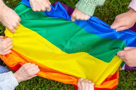 Group Of People Holding Rainbow Pride Flag In A Hands Gay And Lesbian Concept Lgbtq Stock