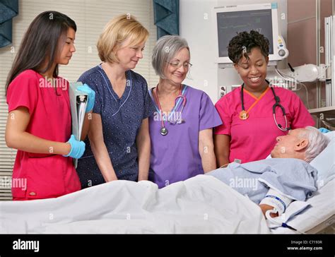 Nurses Talk To A Patient In A Hospital Room Stock Photo Alamy