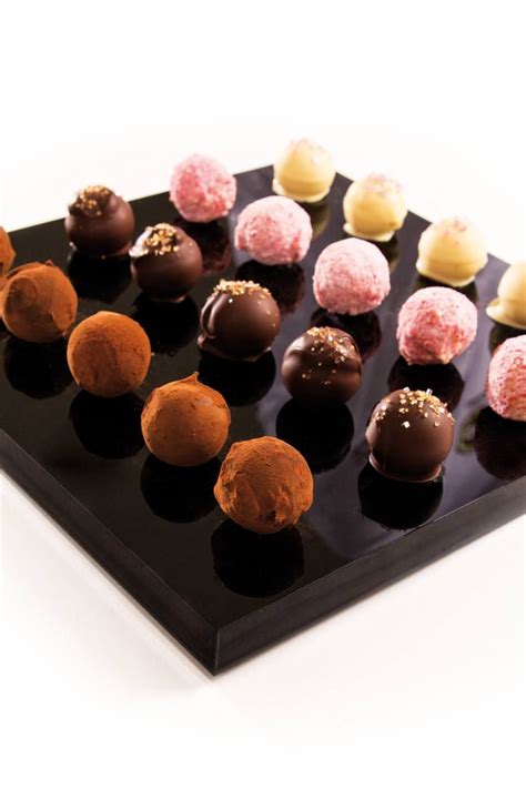 How to make chocolate truffles. Four different Truffle shells filled with an orange ...