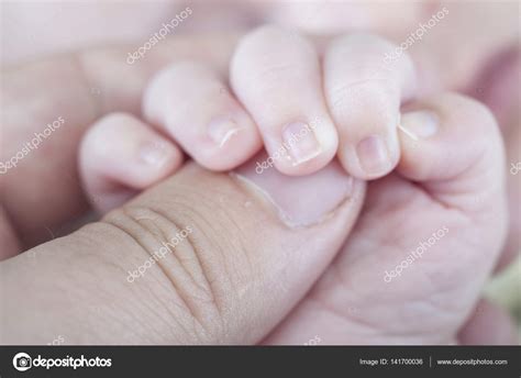 Hand Of Newborn Holding Father — Stock Photo © Outsiderzone 141700036
