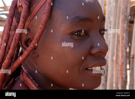 A Portrait Of A Himba Woman Whose Hair And Skin Is Tinged With Ochre