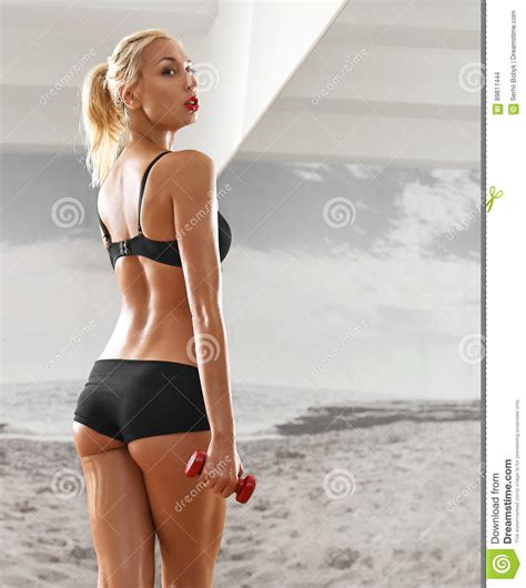Sexy Athletic Blonde Woman In The Gym Against The Background Stock