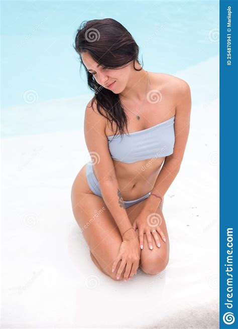 Beautiful Tanned Sporty Slim Woman Relaxing In White Swimming Pool With