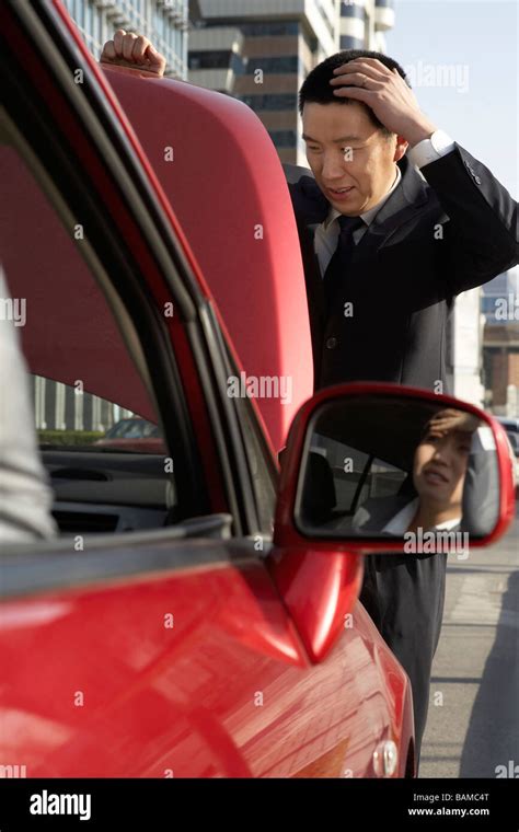Businessman Trying To Fix Car Stock Photo Alamy