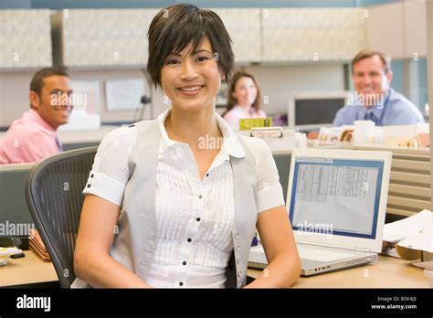 Businesswoman In Cubicle Smiling Stock Photo Alamy