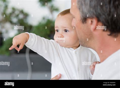 Close Up Of Father With His Cute Baby Daughter Pointing Stock Photo Alamy