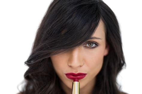 Premium Photo Sensual Brunette Applying Red Lipstick
