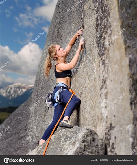 Female Climber Climbing With Rope On A Rocky Wall Stock Photo By