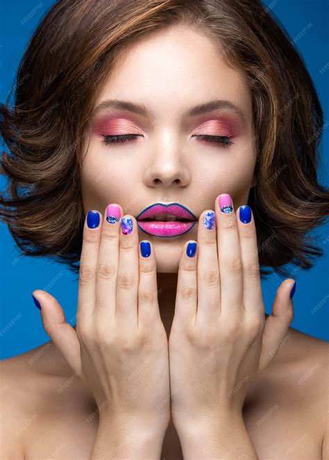 premium photo beautiful model girl with bright makeup and colored nail polish beauty face
