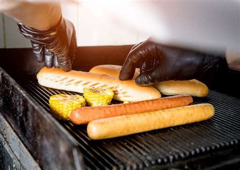 Premium Photo Chef Cooking Two Hot Dogs On A Grill Restaurant
