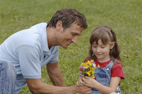 Father Giving Flowers To Daughter Smiling Stock Photo