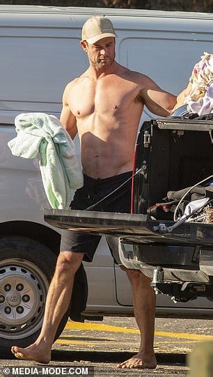 elsa is one lucky lady chris hemsworth displays his rippling abs and bulging biceps as he gets