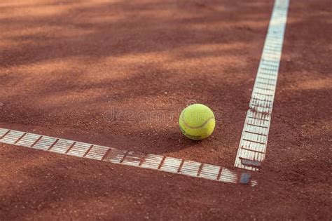 Closeup Shot Of A Yellow Tennis Ball In A Tennis Court Stock Image