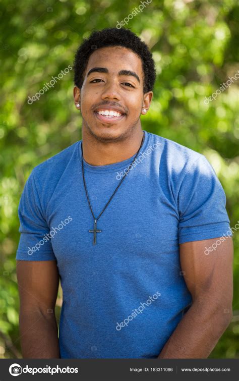 African American Teenage Boy Smiling Stock Photo By ©pixelheadphoto