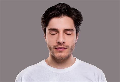 Portrait Of Handsome Millennial Man With Closed Eyes Stock Photo