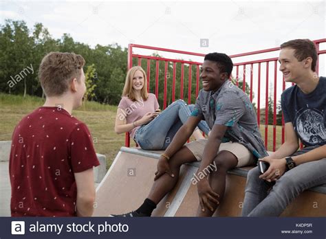 Teenage Friends Talking And Hanging Out At Skate Park Stock Photo Alamy