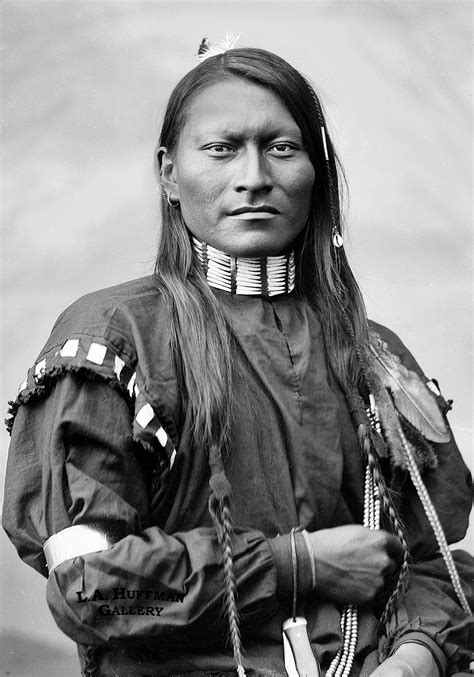 An Old Black And White Photo Of A Native American Woman