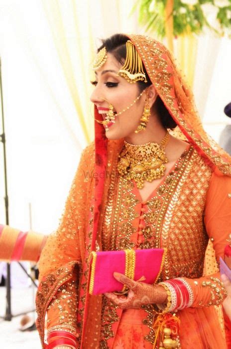 India's most liked ethnic wear store for anarkali & salwar suits. Photo of Candid Bride in Orange Anarkali by Sabyasachi