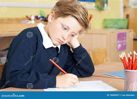 Bored Male Elementary School Pupil At Desk Stock Image Image Of Class