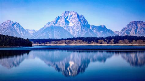 Download Wallpaper 1366x768 Lake Reflections Mountains Calm Sunny