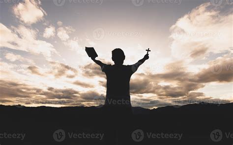 Silhouette Of A Woman With Hands Raised In The Sunset Concept For