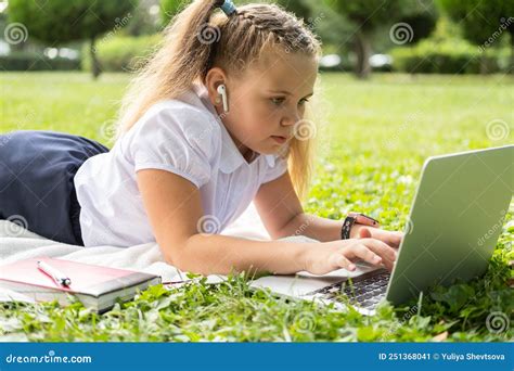 Happy Kid Girl On School Uniform With Wireless Headphone Has Online