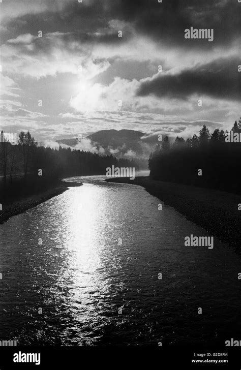 Sunrise Over Forest Lined River Stock Photo Alamy