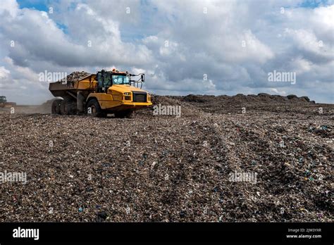 A Dumper Truck On A Large Waste Management Landfill Site Dumping