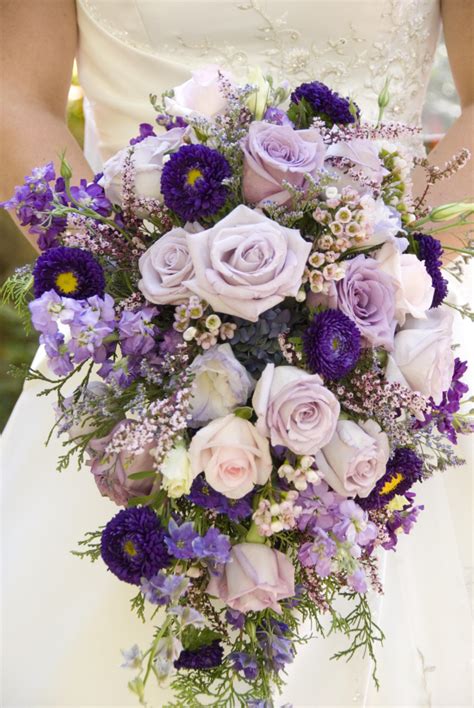 They are widely used across the world and is the national flower for the united states and june becoming the national rose month. Lavender and purple cascade bridal bouquet. | Bridal ...