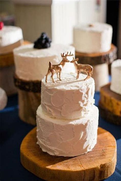 Each tier of your cake doesn't need to be the same height. two-tier winter wedding cake with deer cake toppers | Deer Pearl Flowers
