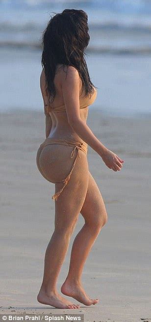 Kim Kardashian Reveals Inflated Beach Bum In Tiny Bikini