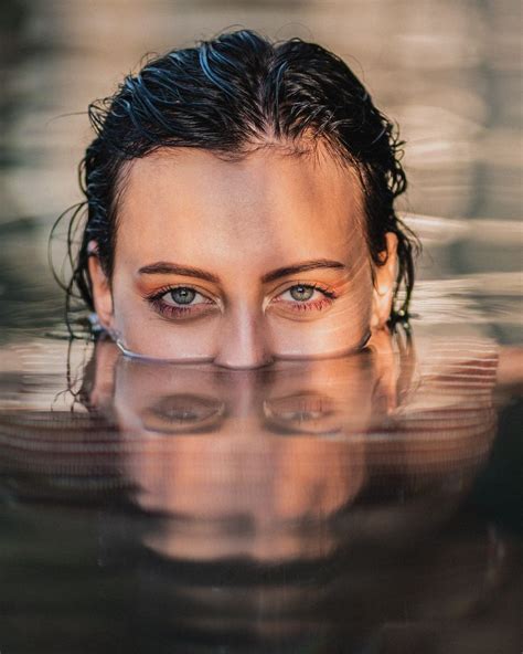 A Woman Is Submerged In The Water With Her Eyes Wide Open