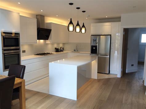When lighting your kitchen island, the kind of light your fixtures will cast is just as important as how the fixture looks in your space. Light, bright kitchen with LED lighting above cabinets and ...