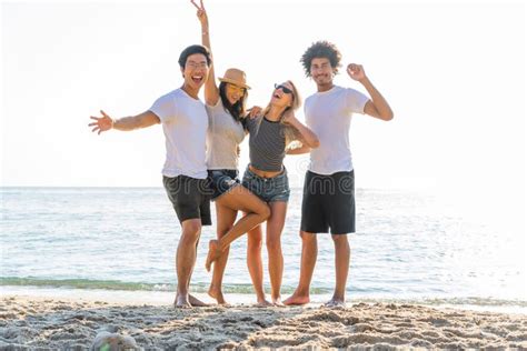 Portrait Of Excited Young Friends Standing On The Beach Multiracial