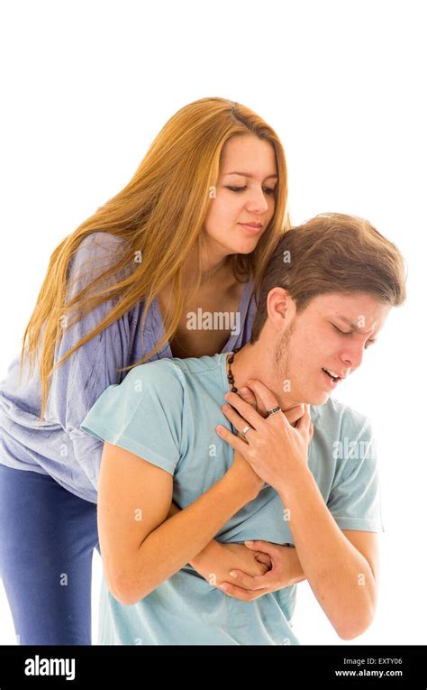 Couple Demonstrating First Aid Procedure For Abdominal Thrusts Heimlich Manoeuvre Or Maneuver