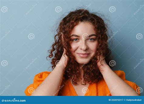 Happy Redhead Curly Girl Smiling And Covering Her Ears Stock Image