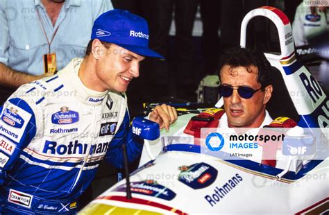 David Coulthard Talks With Sylvester Stallone Who Is Sitting In Damon