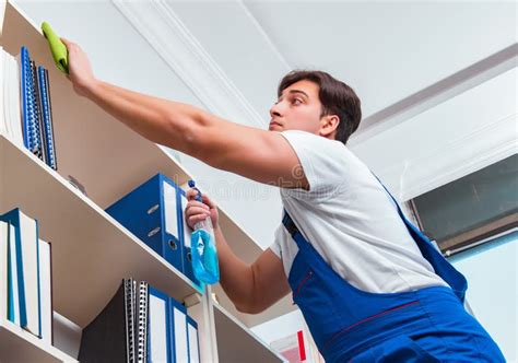 Male Office Cleaner Cleaning Shelves In Office Stock Photo Image Of