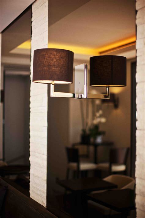 By adding interior wall lighting, like a wallchiere, rooms seem to have additional depth. smoky brown mirrored glass with stylish wall sconce - Eric ...