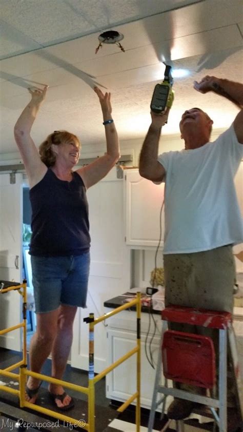 I love that you covered up that popcorn! Covering Popcorn Ceiling with Wood Planks - My Repurposed ...